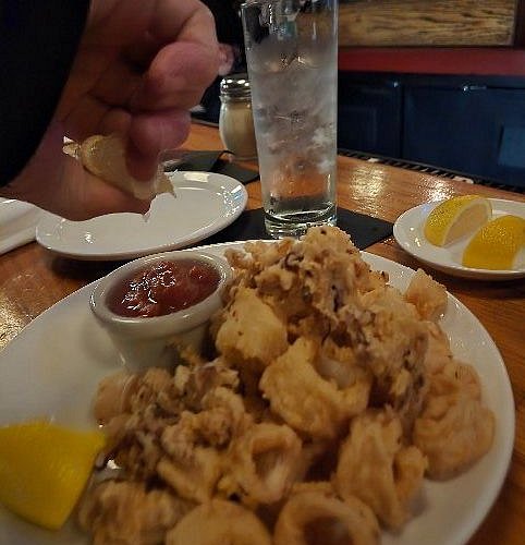 The Left Bank signature dishes Pan-Seared Scallops, Steak Frites, Crispy Calamari